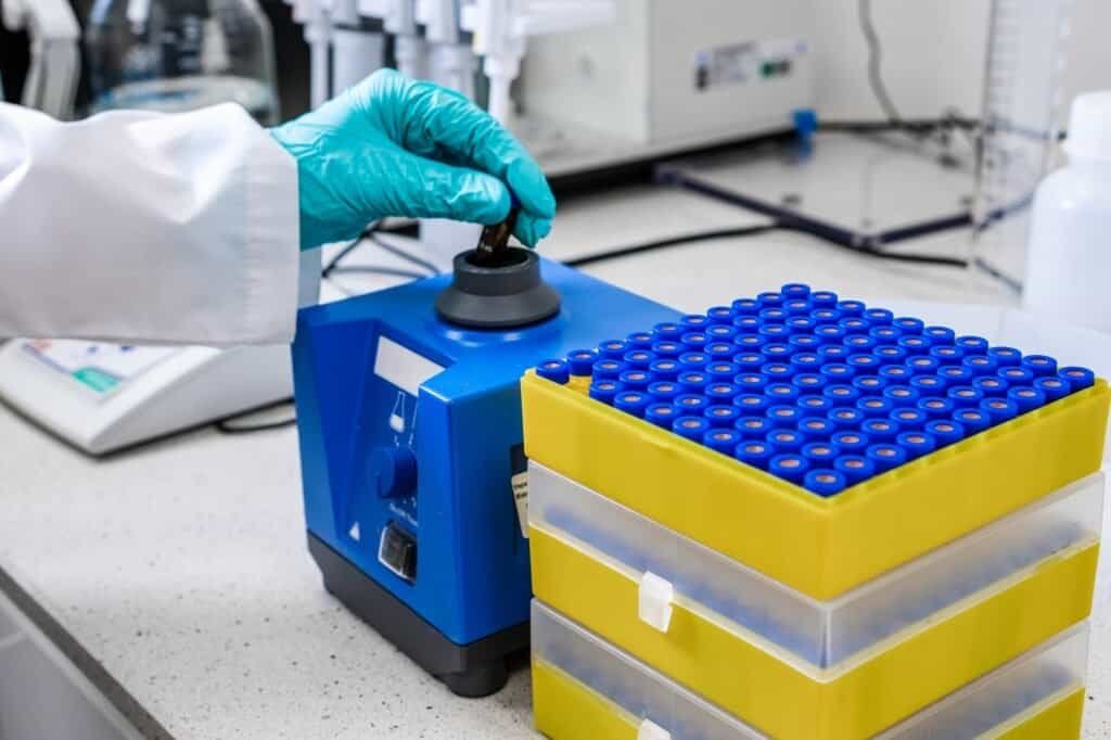 Before HPLC analysis, a chemist agitates the samples using a vortex mixer.