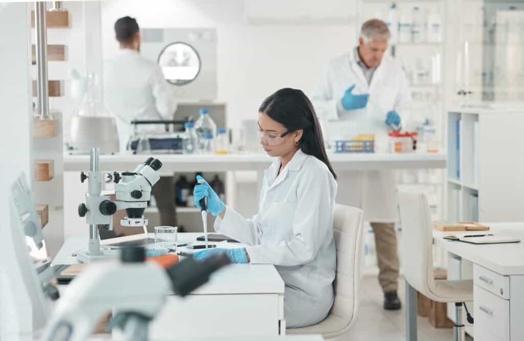 Analysing the sample extensively. Shot of a young scientist working with samples in a lab.