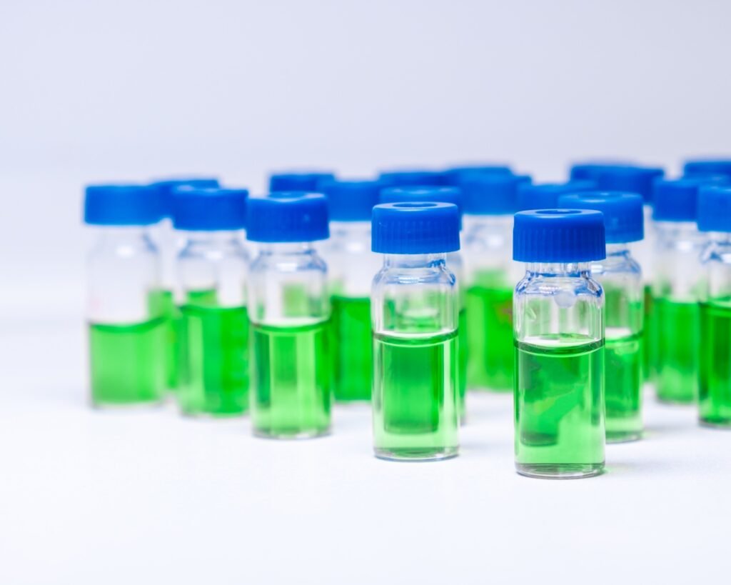 HPLC vials with green sample of plant extracts. Developing of drugs based on natural products