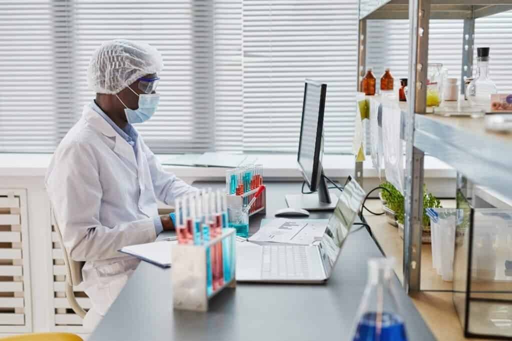 Man examining samples in test tubes