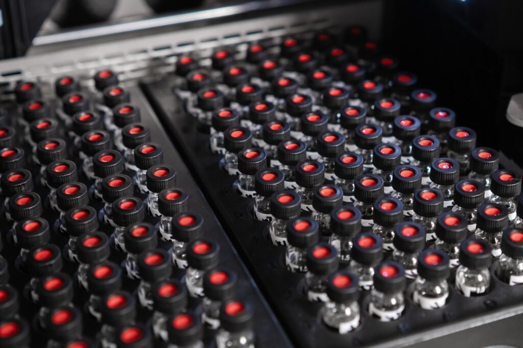 Autosampler picks up a vial and collects samples before injecting them for HPLC analysis.