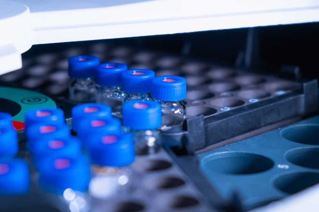 Vials with blue caps in the rack of auto sample for LC MS analysis.