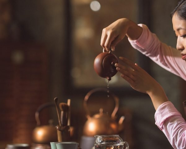 Young woman pouring tea